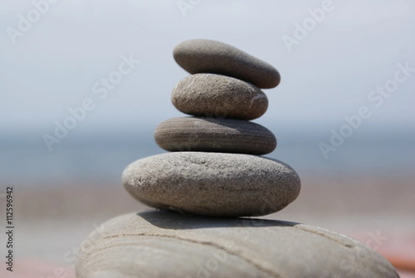 Fototapeta Balanced stones with sea and sky landscape background.