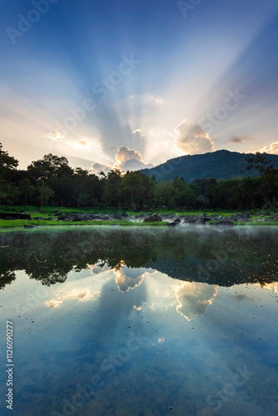 Fototapeta Hot springs over rock terrain with misty and morning sunrise rays and Natural Mineral Water of Chae Son National Park in Lampang Province, Thailand.