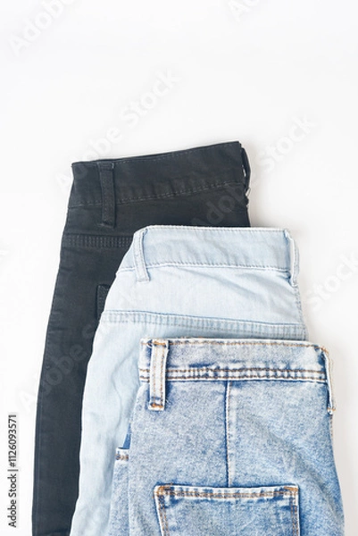 Fototapeta Pile of pants for men isolated on a white background with clipping path