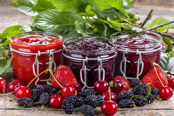 Obraz strawberry, cherry and mulberry jam on a rustic table