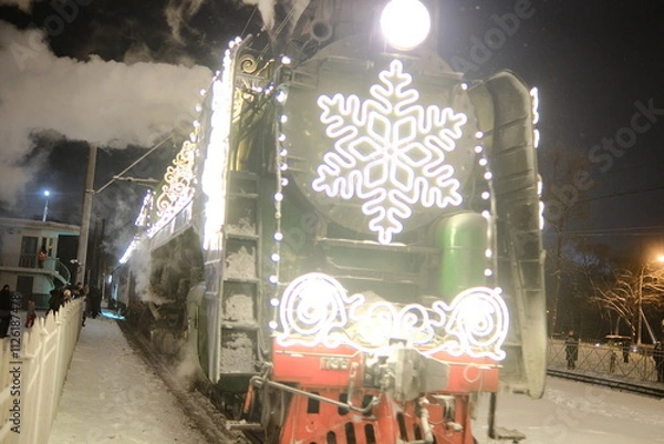 Fototapeta Christmas train with steam locomotive and illumination