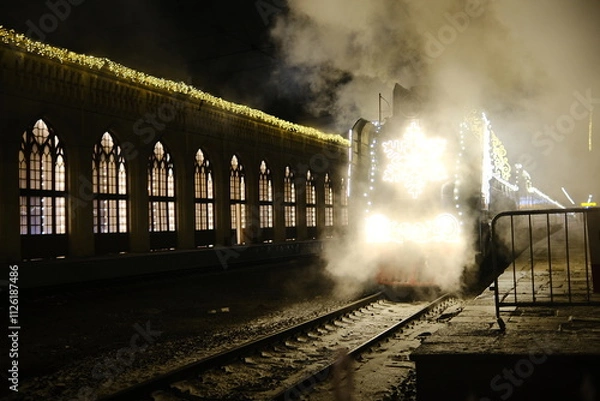 Fototapeta Christmas train with steam locomotive and illumination