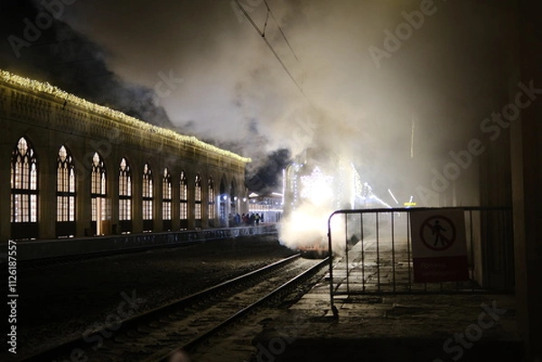 Fototapeta Christmas train with steam locomotive and illumination