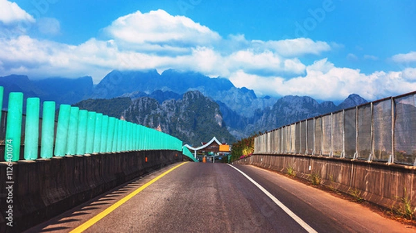 Fototapeta A road connecting cities with beautiful overlapping mountain views