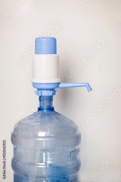 Obraz Manual water pump dispenser isolated against white background vertical