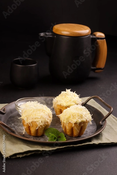 Obraz Ensaymada is Filipino Soft Bread, Covered with Butter and Sugar then Topped with Greated Cheese. 