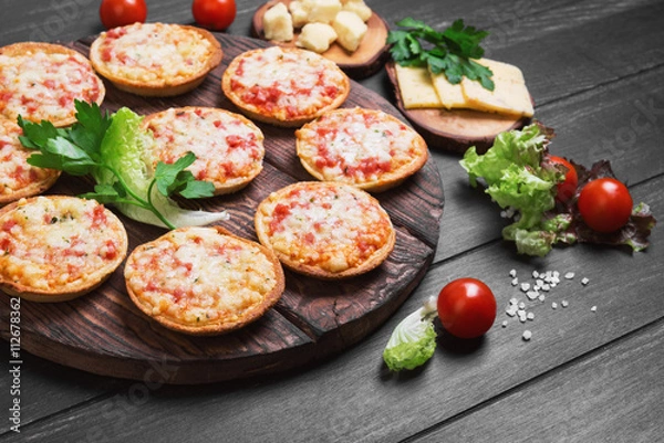 Fototapeta Small pizza with mozzarella cheese