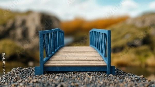 Obraz The handmade woodwork. Miniature blue bridge over pebbles with blurred nature background.