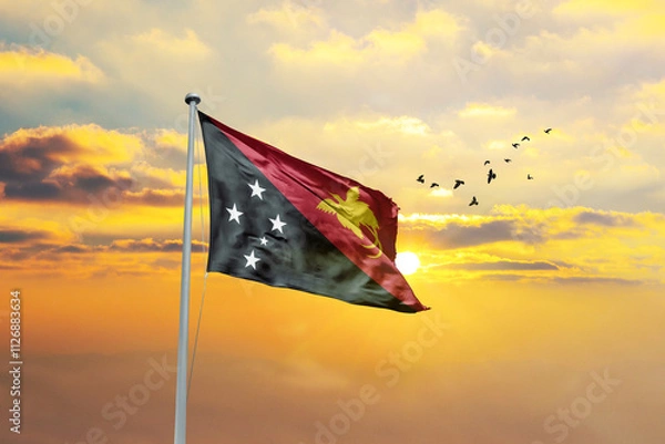 Obraz Waving flag of Papua New Guinea against sunset or sunrise. Papua New Guinea flag for Republic Day and Independence Day.