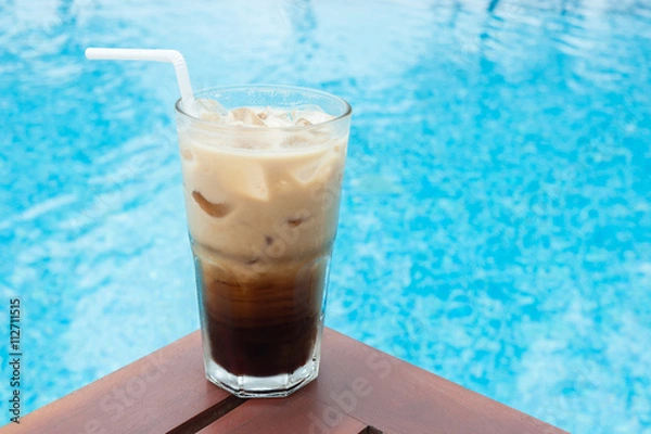 Obraz Iced coffee on the table beside the pool