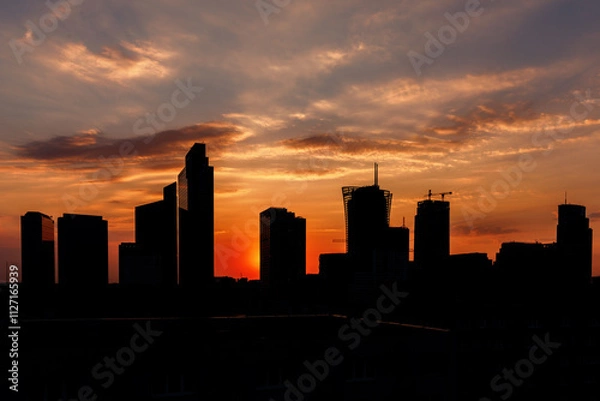 Fototapeta A Sunset Over the City Skyline, Illuminating the Urban Landscape