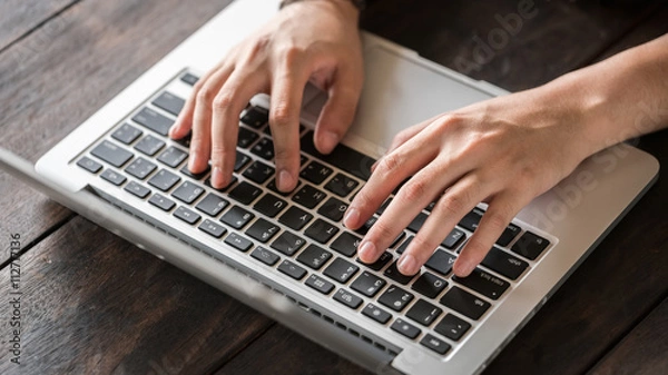 Obraz Student typing a report in the laptop