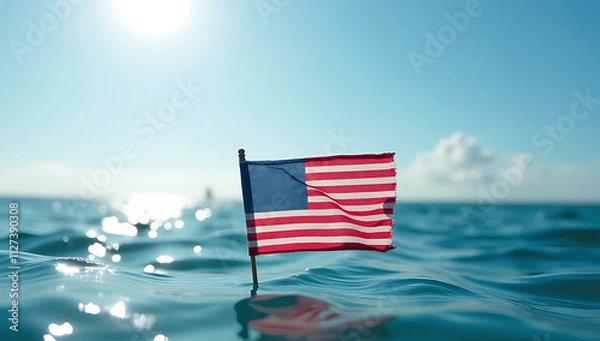 Fototapeta A small American flag is made from recycled business paper floating in the ocean under sunny weather conditions to promote economic awareness._00001_