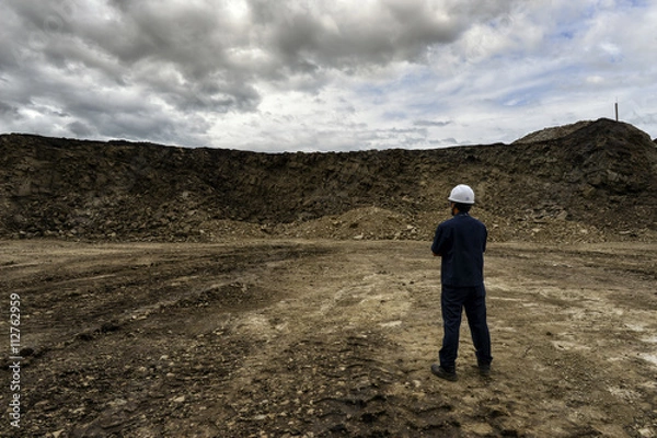 Fototapeta The worker man at mine on beautifu sky