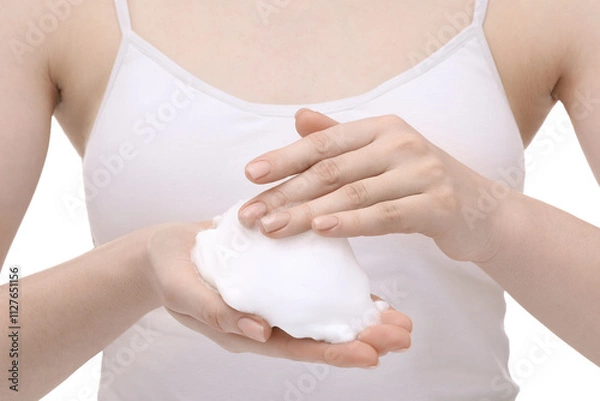 Fototapeta Woman with cleansing foam on hands against white background, closeup