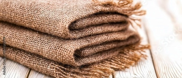 Fototapeta Textile crafting rustic burlap fabric stacked on wooden surface natural environment close-up view textures and patterns