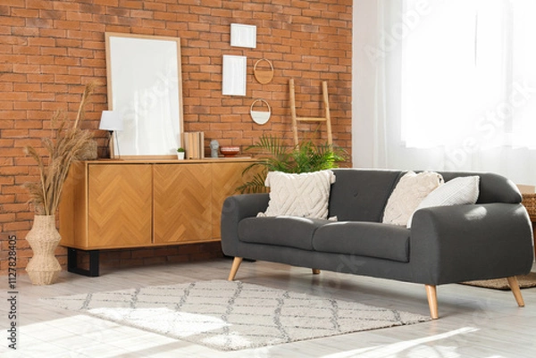 Fototapeta Interior of modern living room with sofa, commode and frames