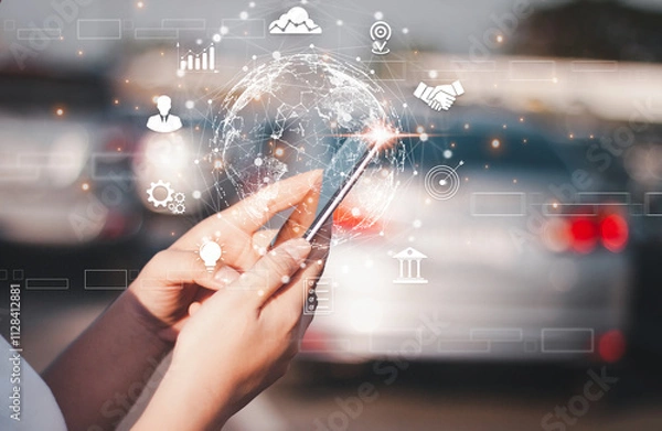 Fototapeta Hands holding a smartphone displaying a glowing digital globe with futuristic business icons overlayed, representing global connectivity.