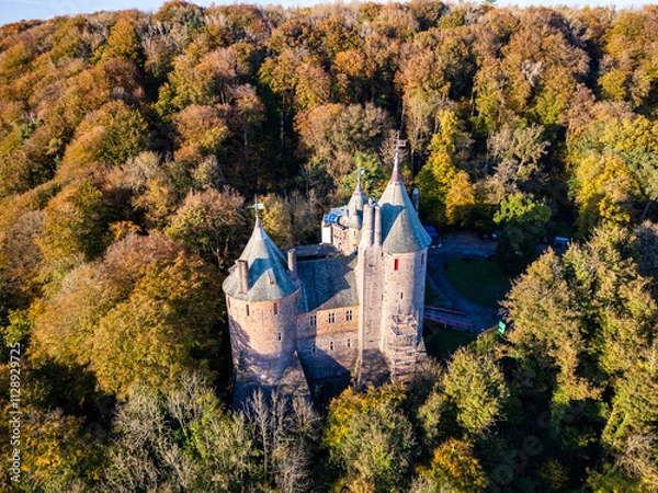 Obraz Aerial view of a medieval fairy tale castle surrounded by beautiful autumn foliage (Castell Coch, Wales)