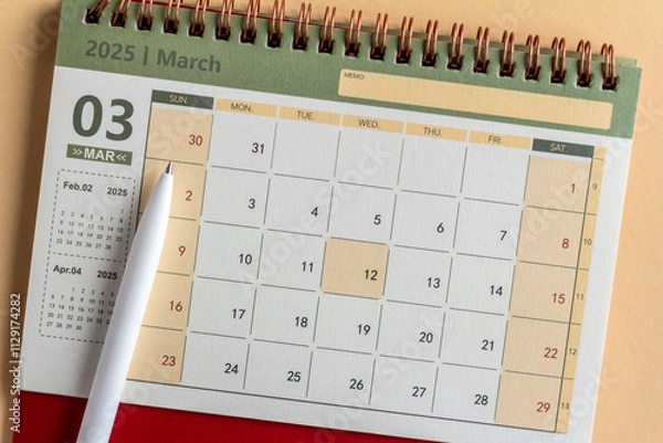 Fototapeta March 2025 on the table. Desk calendar for planning and organizing time.