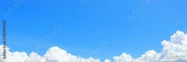 Fototapeta Border of blue sky with fluffy white clouds along the top and bottom edges, fluffy