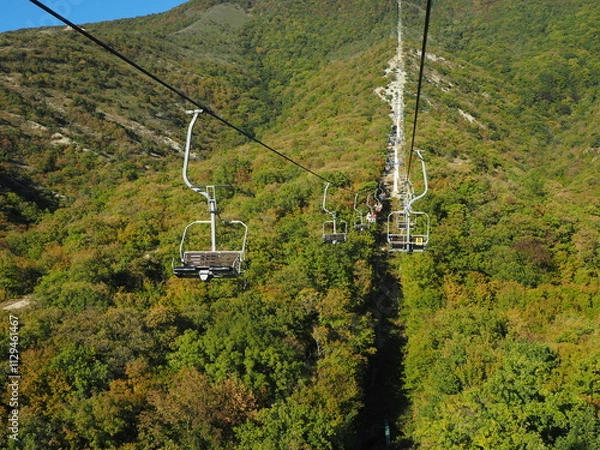 Obraz Cable car in the mountains on a background of blue sky.