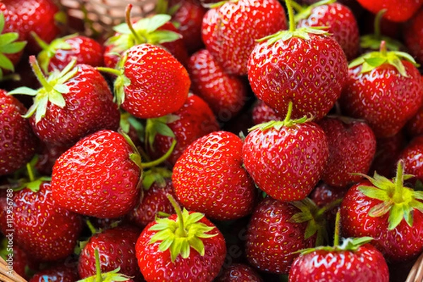 Fototapeta Very beautiful background with fresh strawberries in a wicker heart shaped wickerwork basket