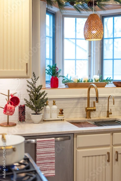 Obraz Cozy small kitchen decorated for Christmas with pine branches and touches of red decor