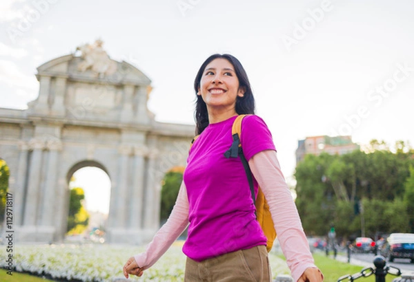 Obraz Young peruvian student exploring madrid's Puerta de Alcala near retiro park