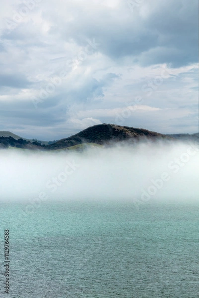 Obraz Mountains by the sea with natural fog. 