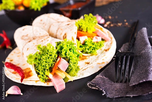 Fototapeta Shawarma sandwich, fresh roll of lavash (pita bread) pork shawarma with ham and cheese
