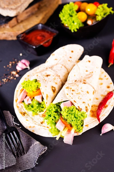 Fototapeta Shawarma sandwich, fresh roll of lavash (pita bread) pork shawarma with ham and cheese