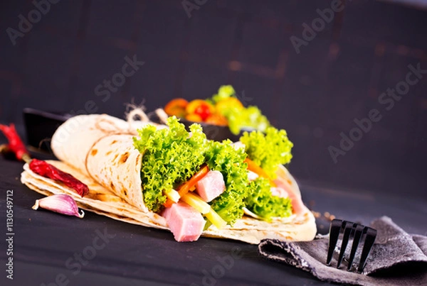 Fototapeta Shawarma sandwich, fresh roll of lavash (pita bread) pork shawarma with ham and cheese