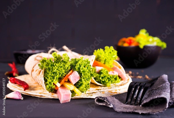 Fototapeta Shawarma sandwich, fresh roll of lavash (pita bread) pork shawarma with ham and cheese