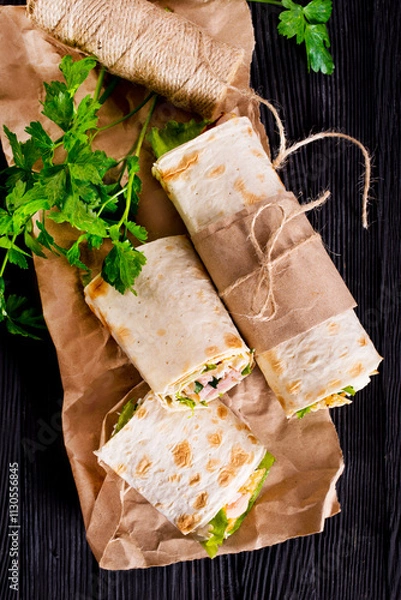 Fototapeta Shawarma sandwich, fresh roll of lavash (pita bread) pork shawarma with ham and cheese