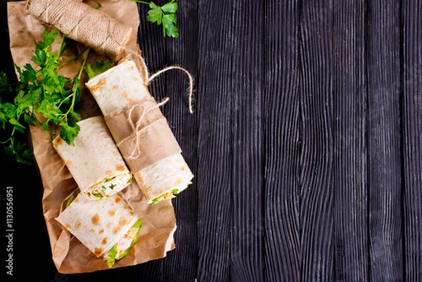 Fototapeta Shawarma sandwich, fresh roll of lavash (pita bread) pork shawarma with ham and cheese