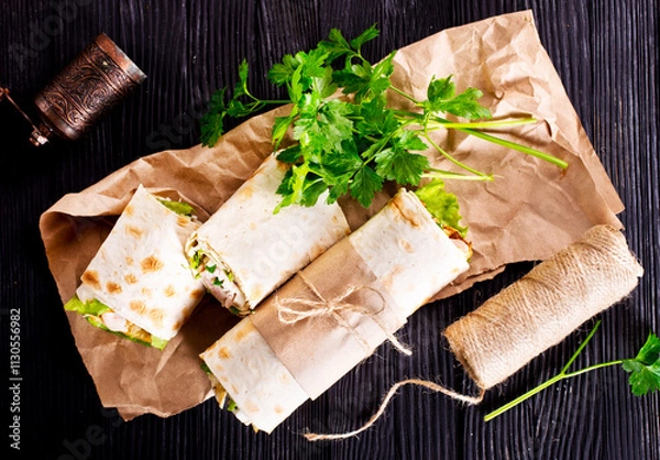 Fototapeta Shawarma sandwich, fresh roll of lavash (pita bread) pork shawarma with ham and cheese