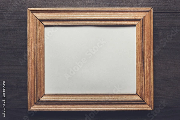 Fototapeta old empty frame on wooden wall