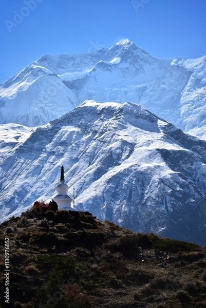 Obraz Buddhist stupas, monuments and prayer flags in the tall himalayan mountains of Nepal.