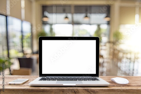 Fototapeta Laptop with blank screen on table of a cafe
