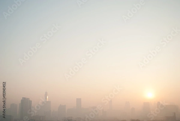 Obraz smog cityscape at sunset and blue sky