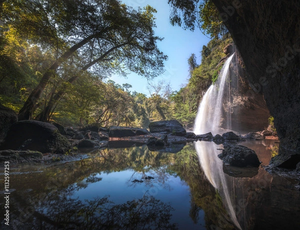 Obraz Scenic waterfall in Khao Yai National Park, Thailand, surrounded by lush green jungle. The cascading water flows into a serene pool below, offering a tranquil escape into the heart of nature's beauty.