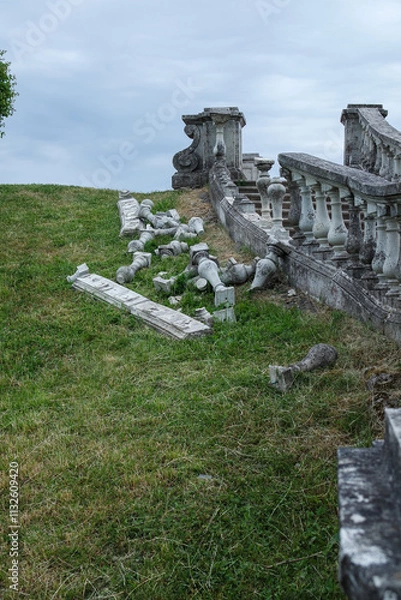 Fototapeta view of an old destroyed stone staircase against the backdrop of a green lawn