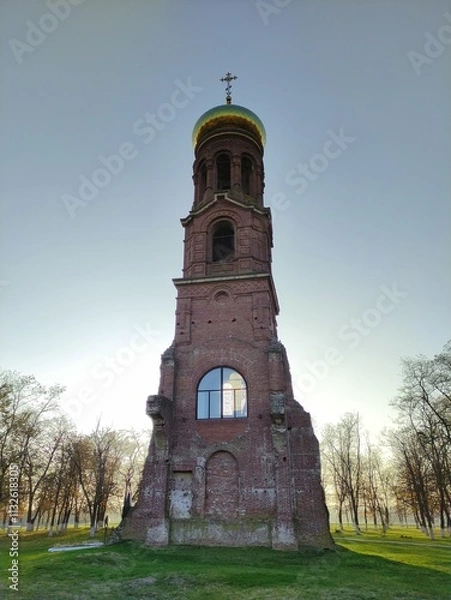 Obraz Old Christian Orthodox chapel against blue sky and tree branches