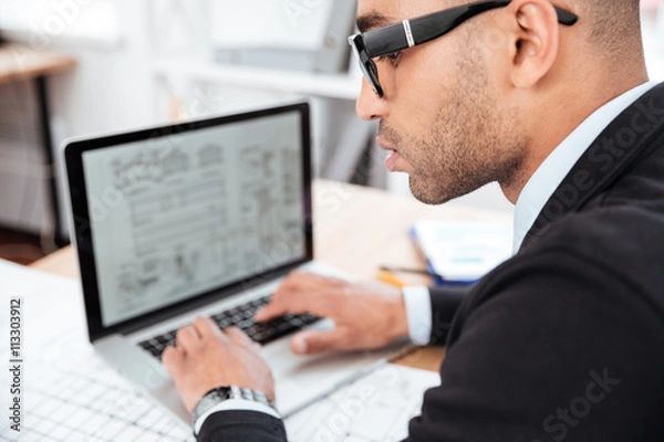 Fototapeta Close-up portrait of a pensive businessman in office