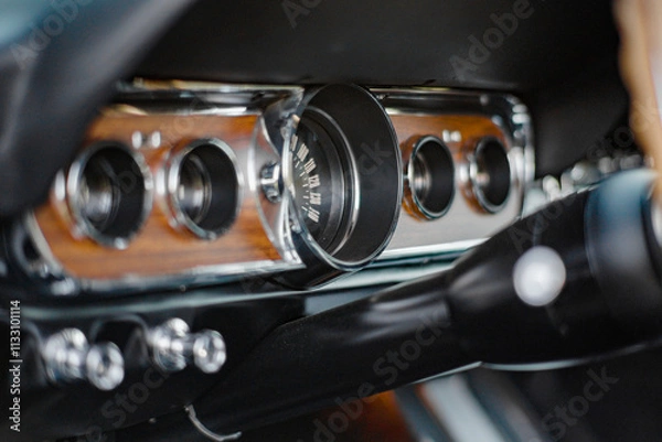 Obraz Close-Up View of Vintage Car Dashboard With Wood Paneling and Chrome Details