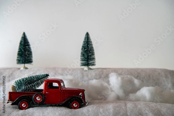Obraz red pickup truck with pine tree in snow with white background and room for copy