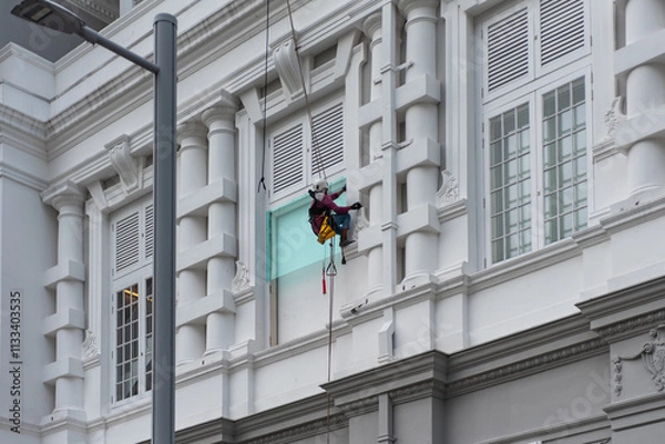 Obraz Acrobatic Mayson At Work Harnessed On A Building