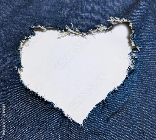 Fototapeta the heart forms an opening in the blue denim.