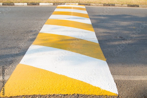 Obraz Speed bump for slowing traffic. Selective focus.
